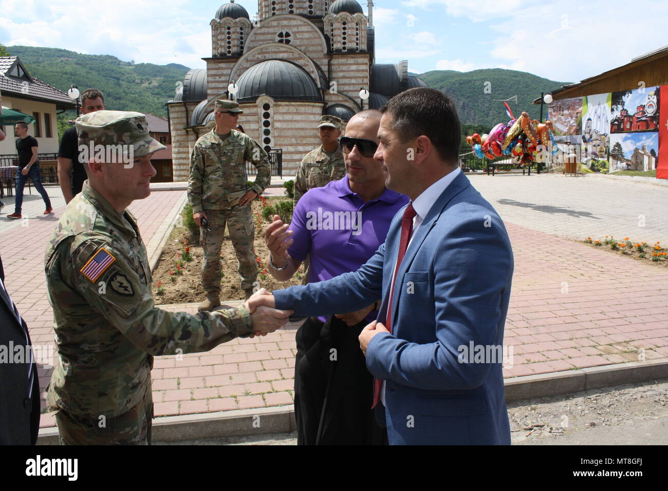 Lt. Col. Donald Braman, commander of 3rd Squadron, 61st Cavalry Regiment, 2nd Infantry Brigade Combat Team, 4th Infantry Division, meets Leposavic Mayor Zoran Todic during the Saint Vasilije Ostroški Festival on May 19 in Leposavic, Kosovo. The 3-61 CAV is the main maneuver element for KFOR's Multi-National Battle Group - East. (U.S. Army Photo by Capt. Jason Sweeney, 79th Infantry Brigade Combat Team) Stock Photo