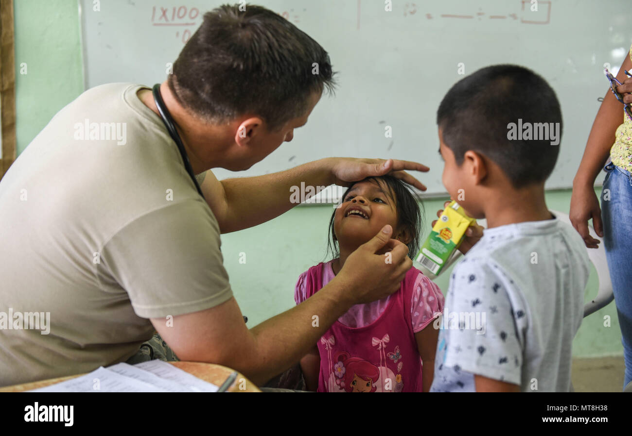 U.S. Air Force Maj. Eldon Palmer, 346th Expeditionary Medical Operations Squadron pediatrician, checks the health of a child May 11, 2018 in the Coclé Province of Panama. So far, in 2-weeks’ worth of Medical Readiness Training Exercises the teams, working in conjunction with the Panamanian Ministry of Health, have seen nearly 4,700 patients and 502 animals. The medical team is participating in Exercise New Horizons 2018, which is a joint training exercise focused on civil engineer, medical, and support service personnel’s ability to prepare, deploy, operate, and redeploy outside the United Sta Stock Photo