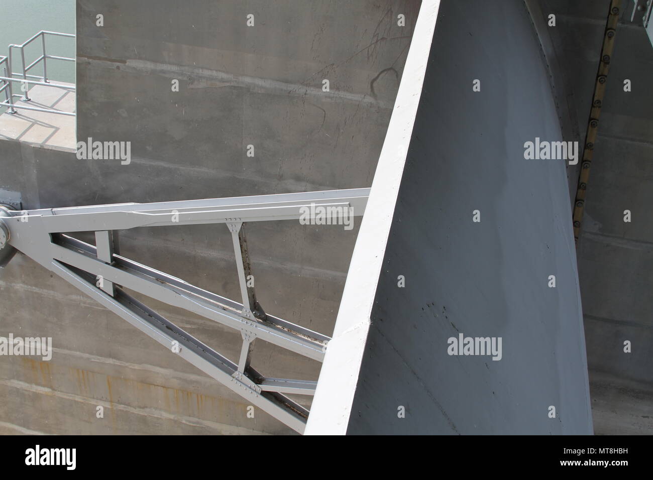 The above view of one of the tainter gates - curved for strength to hold water on the lake side of the dam - which shows the reinforce arms repaired during construction repairs to the Harlan County Dam May 11, 2018. Stock Photo