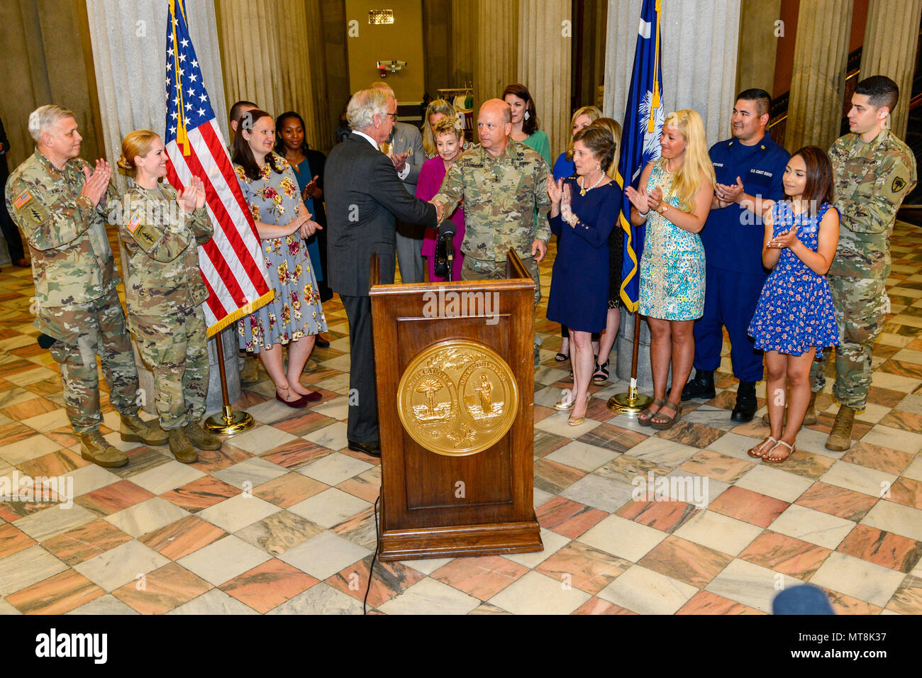 South Carolina Gov. Henry McMaster presents a Proclamation recognizing May as Military Spouse Appreciation month throughout South Carolina, joined by U.S. Army Maj. Gen. Robert E. Livingston, Jr. the adjutant general for South Carolina and his wife Barbara, Fort Jackson's Military Family of the Year, Staff Sgt. John Berta and his wife Agata, U.S. Coast Guard Petty Officer Jerry Stevens and his wife Sarah, and other military members with the spouses from the South Carolina Army and Air National Guard.  Receiving special recognition were four spouses of South Carolina Army National Guard Soldier Stock Photo
