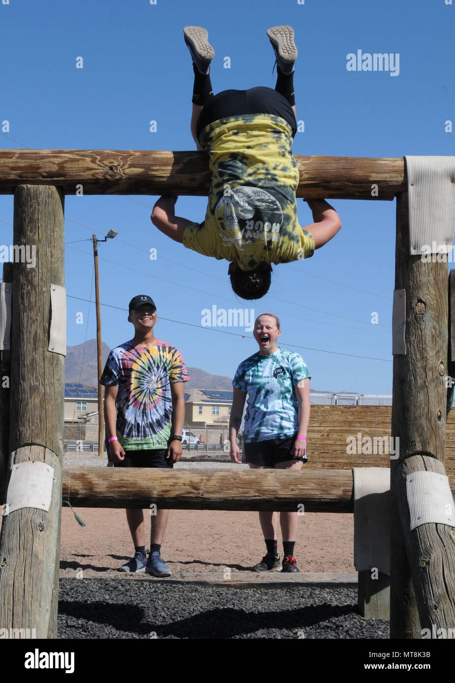 A participant attempts the belly over obstacle as part of the Fort Bliss Old Ironsides Mud Challenge May 12, 2018 at Fort Bliss, Texas. The four-mile course was designed to promote physical fitness while also allowing the community to come together and have fun. (U.S. Army photo by Pfc. Christina Westfall) Stock Photo