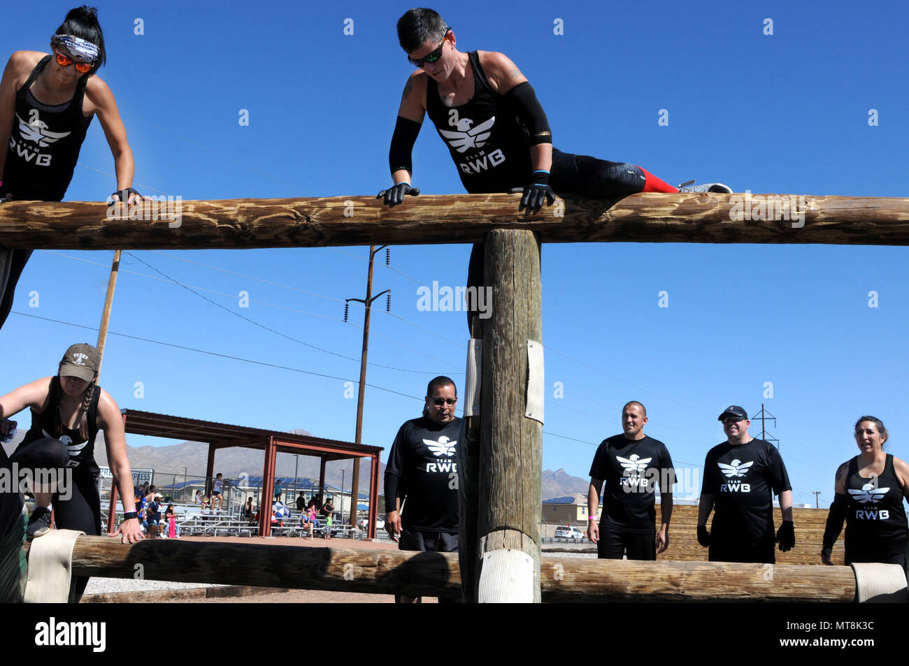 Members of the charity organization, Team Red, White, and Blue participated as a group in the Fort Bliss Old Ironsides Mud Challenge at the air assault obstacle course May 12, 2018 at Fort Bliss, Texas. The four-mile course was designed to promote physical fitness while also allowing the community to come together and have fun. (U.S. Army photo by Pfc. Christina Westfall) Stock Photo