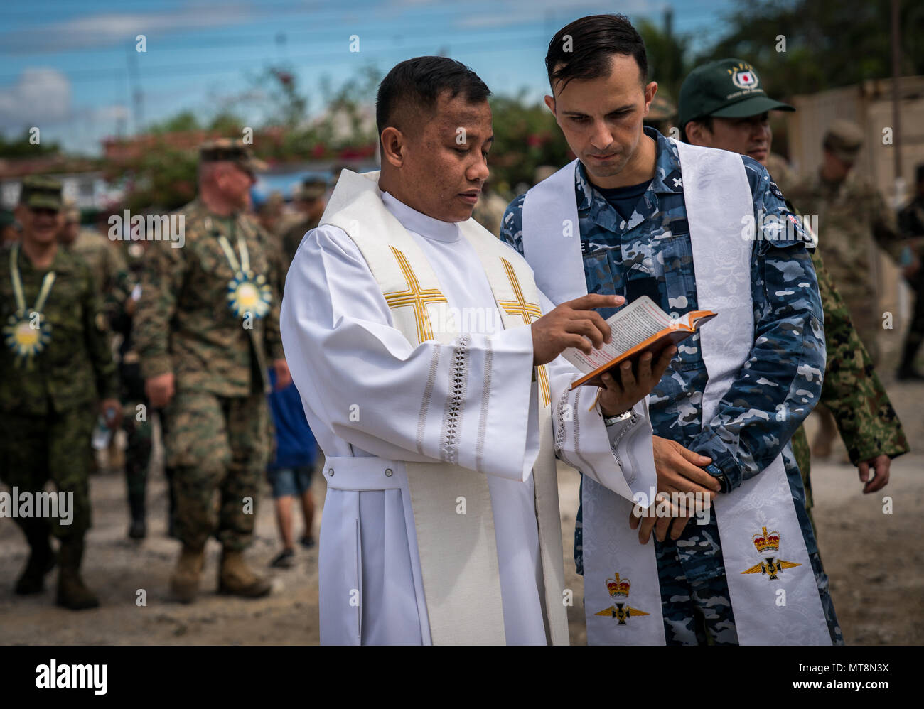 Royal Australian Air Force Flight Lt. Rafael Abboud, right, discusses  scripture with his Philippine Army counterpart during the dedication  ceremony for a school building constructed in support of Exercise Balikatan  at Cabu