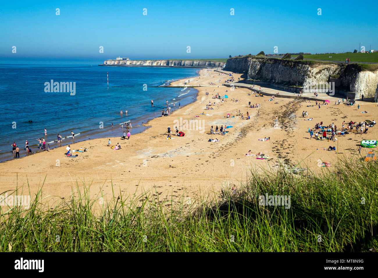 Crowds of beachgoers in the summer at Palm Bay sandy beach near Margate, Kent, UK Stock Photo
