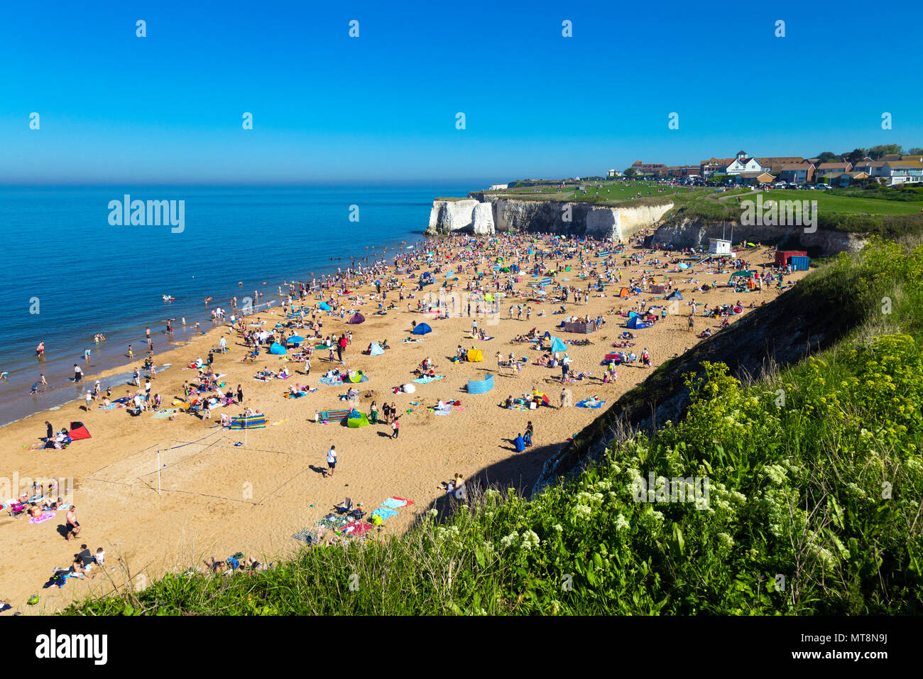 Crowds of beachgoers on the sandy beach of Botany Bay, Kent. UK Stock Photo
