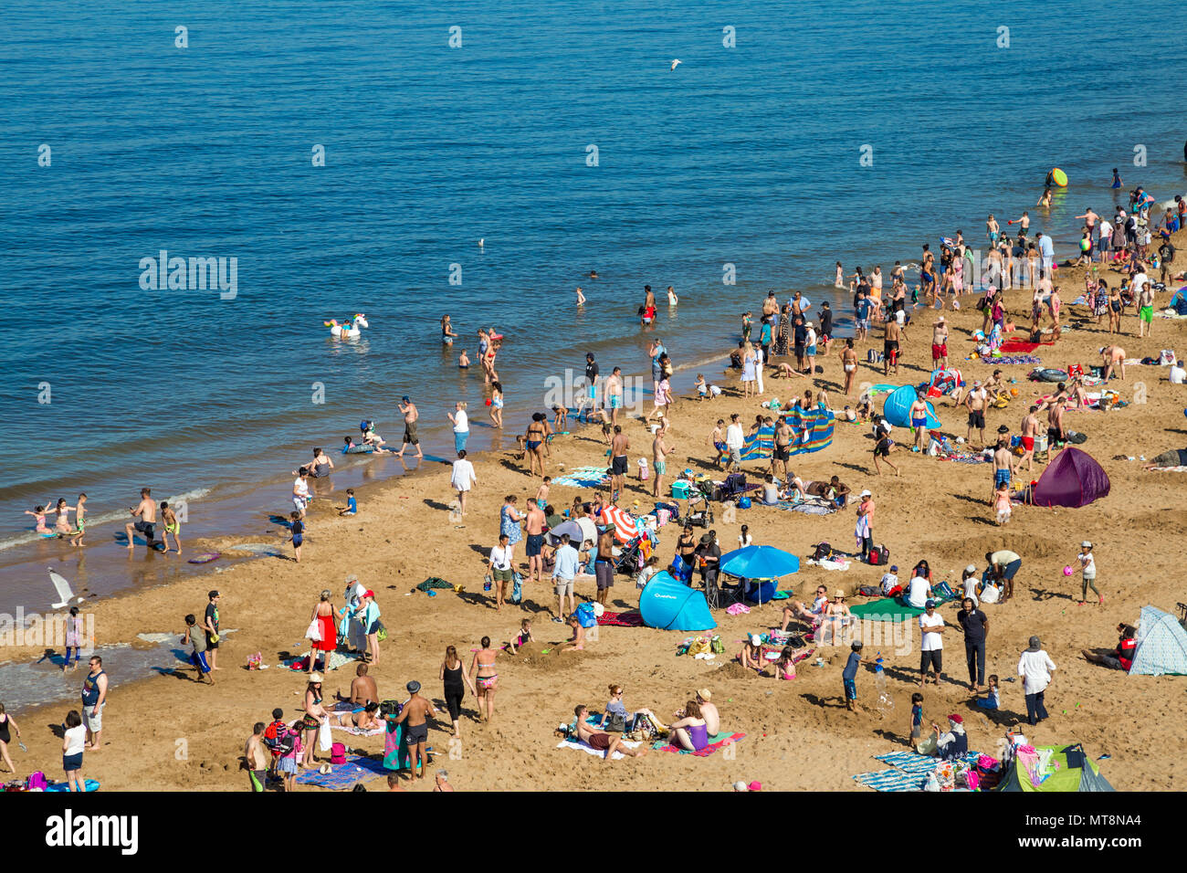 Crowds of beachgoers on the sandy beach of Botany Bay, Kent. UK Stock Photo