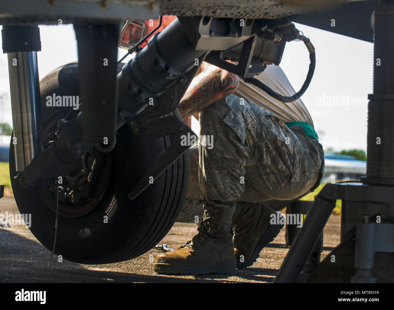 U.S. Air Force Airman 1st Class Joshua Letona, 33d Rescue Maintenance Squadron crew chief out of Kadena Air Base, Japan, and native of Long Beach, California, replaces a tire on the landing gear of an HH-60 Pave Hawk assigned to the 33d Rescue Squadron out of Kadena Air Base, Japan, during Exercise Balikatan, at Clark Air Base, Philippines, May 16, 2018. The HH-60's landing gear needed routine maintenance after returning from a mission during Exercise Balikatan. Exercise Balikatan, in its 34th iteration, is an annual U.S.-Philippine military training exercise focused on a variety of missions,  Stock Photo