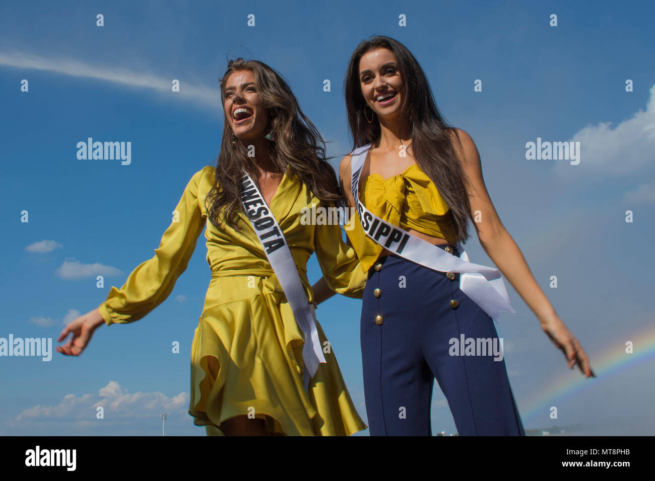 Kalie Wright, Miss Minnesota USA 2018, and Laine Mansour, Miss Mississippi 2018, stand in front of water spray from a fire truck during their tour of Barksdale Air Force Base, Louisiana with other contestants in the 2018 Miss USA pageant. The fire trucks are operated by firefighters assigned to the 2nd and 307th Civil Engineering Squadrons. (U.S. Air Force photo by Airman Maxwell Daigle/Released) Stock Photo
