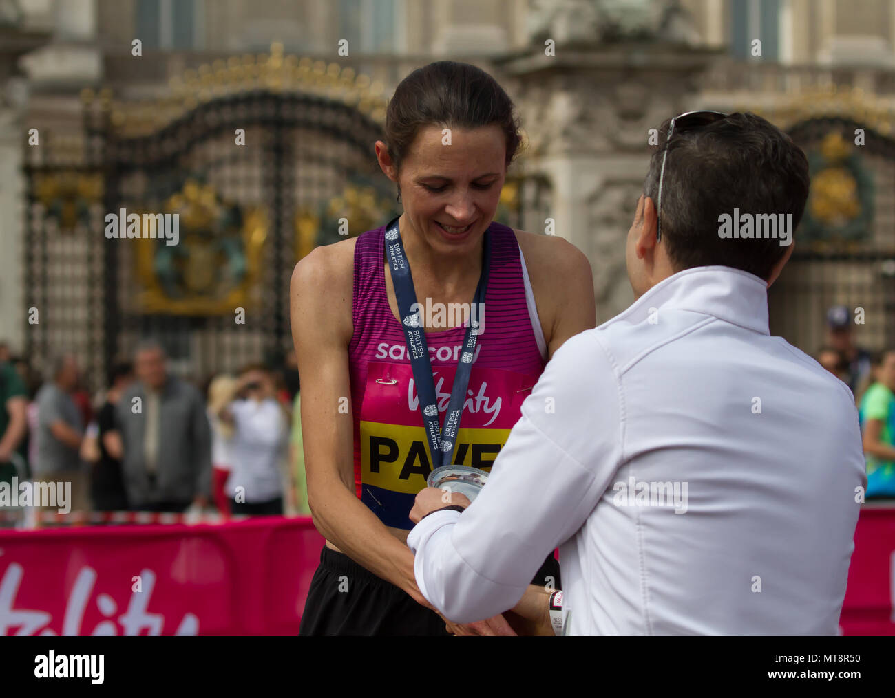 London,UK,28th May 2018,Jo Pavey winner of the Female Vitality London 10,000 collects her medal and trophy in London. The 10K run is now in its 10th year and Jessica Ennis-Hill was present to start the race and present the medals. Credit Keith Larby/Alamy Live News Stock Photo