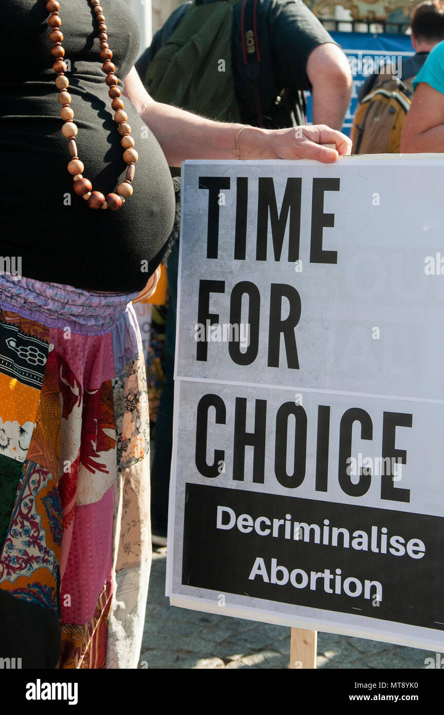 Belfast, Northern Ireland. 28/05/2018 - A pregnant woman holds a placard saying 'Time for Choice.  Decriminalise Abortion'.   Around 500 people gather at Belfast City Hall to call for the decriminalisation of abortion in Northern Ireland.  It comes the day after a referendum held in the Republic of Ireland returned a substantial 'Yes' to removing the 8th amendment to the constitution, which gives equal right of life to both the mother and baby, effectively banning abortion in all circumstances. Stock Photo