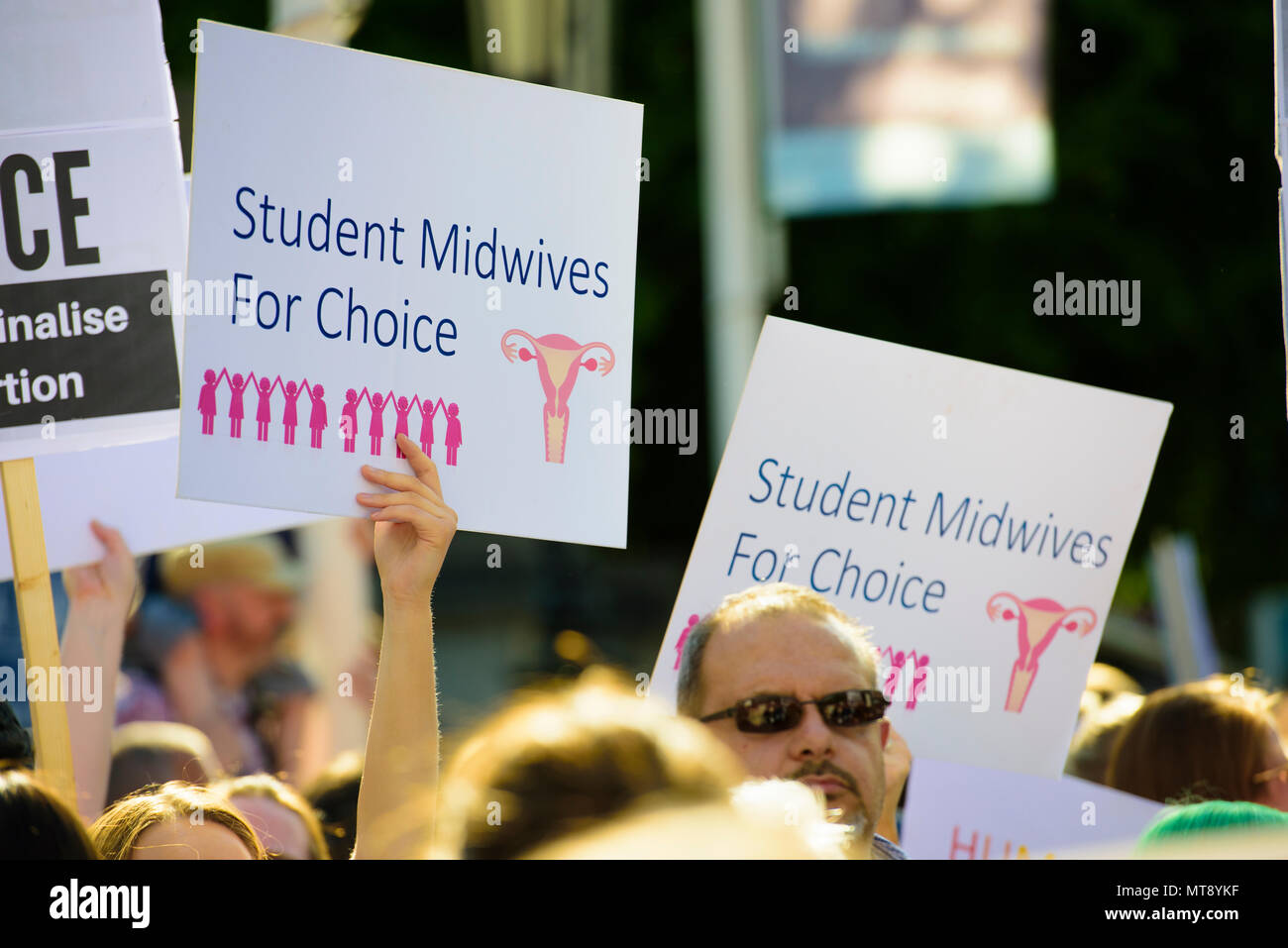 Belfast, Northern Ireland. 28/05/2018 - Protesters hold up placards with the message 'Student midwives for choice'.  Around 500 people gather at Belfast City Hall to call for the decriminalisation of abortion in Northern Ireland.  It comes the day after a referendum held in the Republic of Ireland returned a substantial 'Yes' to removing the 8th amendment to the constitution, which gives equal right of life to both the mother and baby, effectively banning abortion in all circumstances. Stock Photo