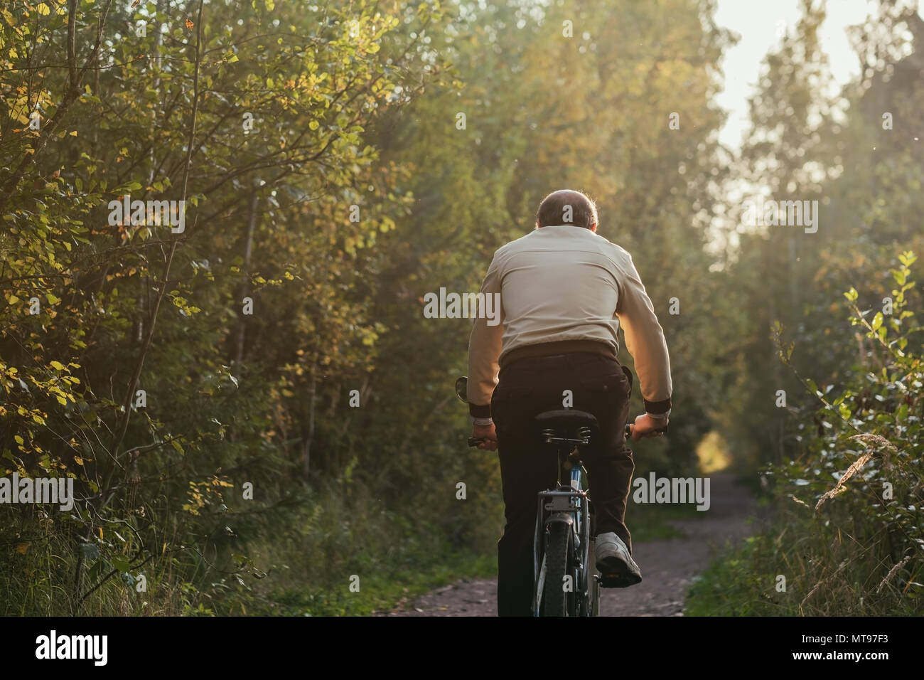 Portrait of man riding cycle in countryside Stock Photo