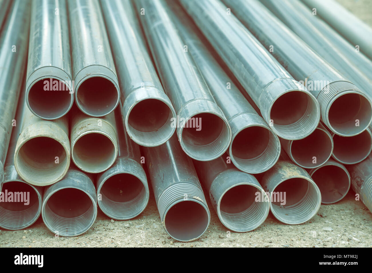 Pile of plastic pipes for water well drilling on the construction site