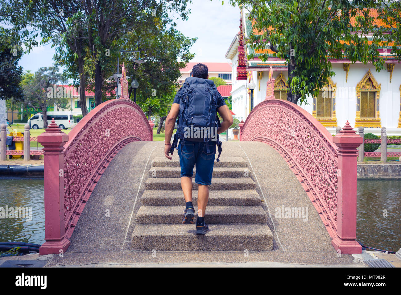 Man backpacher visiting Asia during a sunny day , Solo trip and vacations concept . Stock Photo