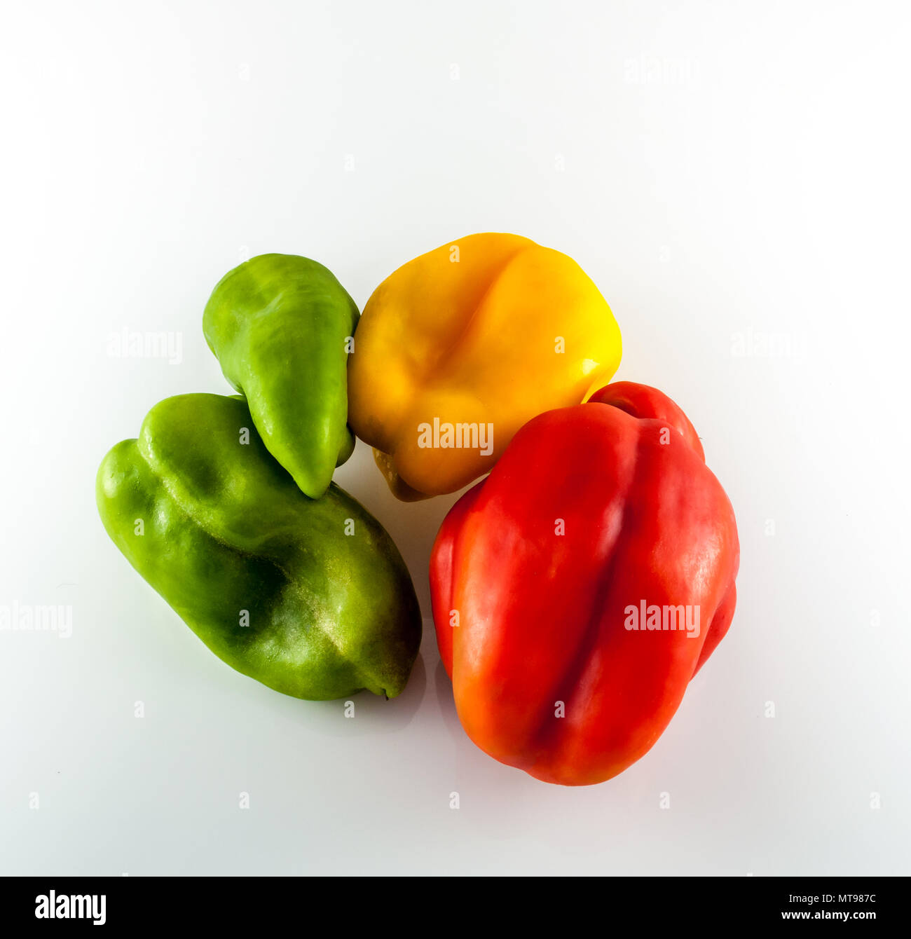 Isolated green, yellow and red peppers on white background Stock Photo ...