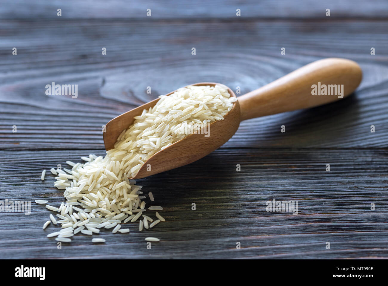 Scoop of uncooked basmati rice Stock Photo Alamy
