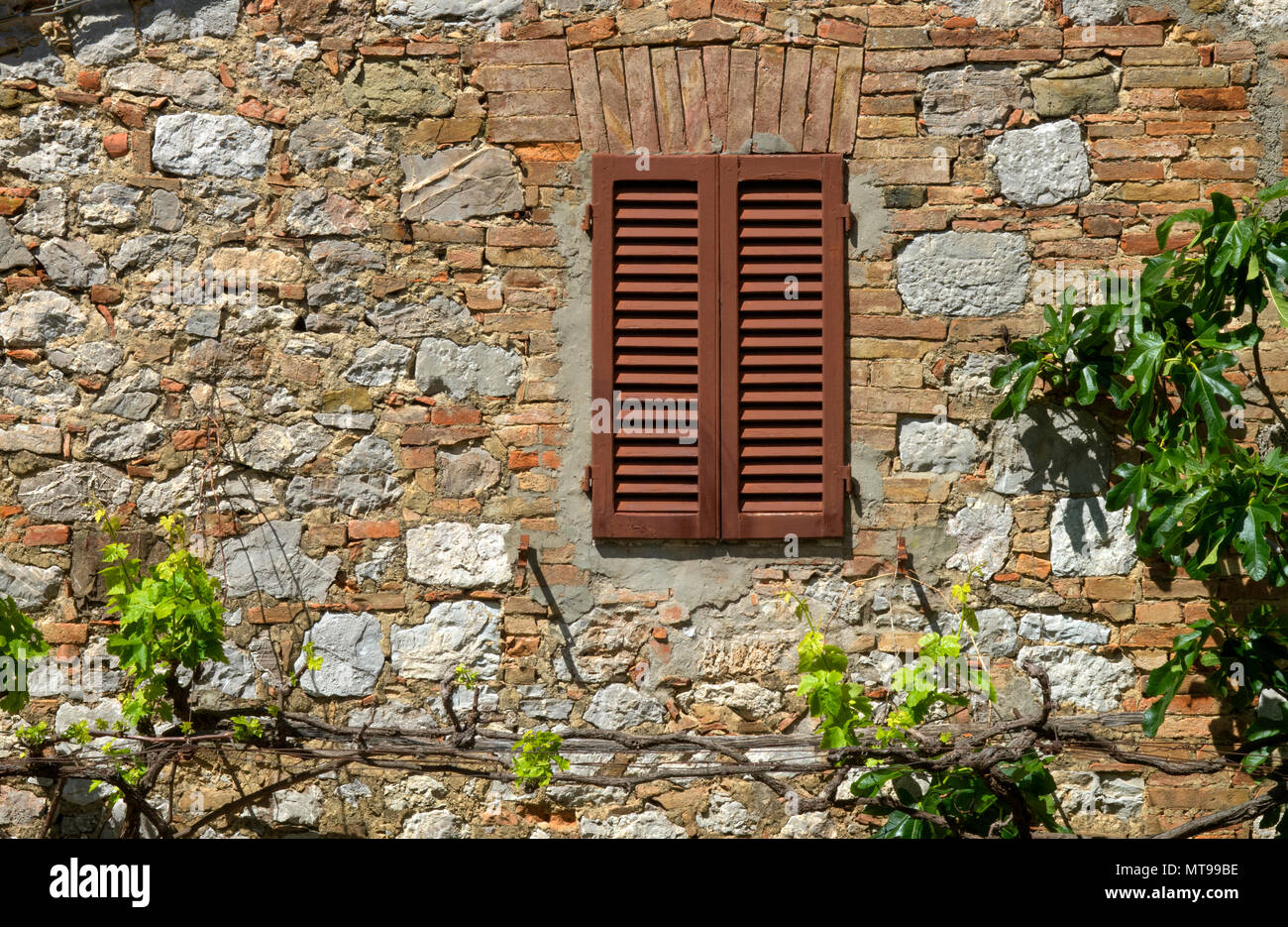 stone wall and window with closed shutters Stock Photo - Alamy