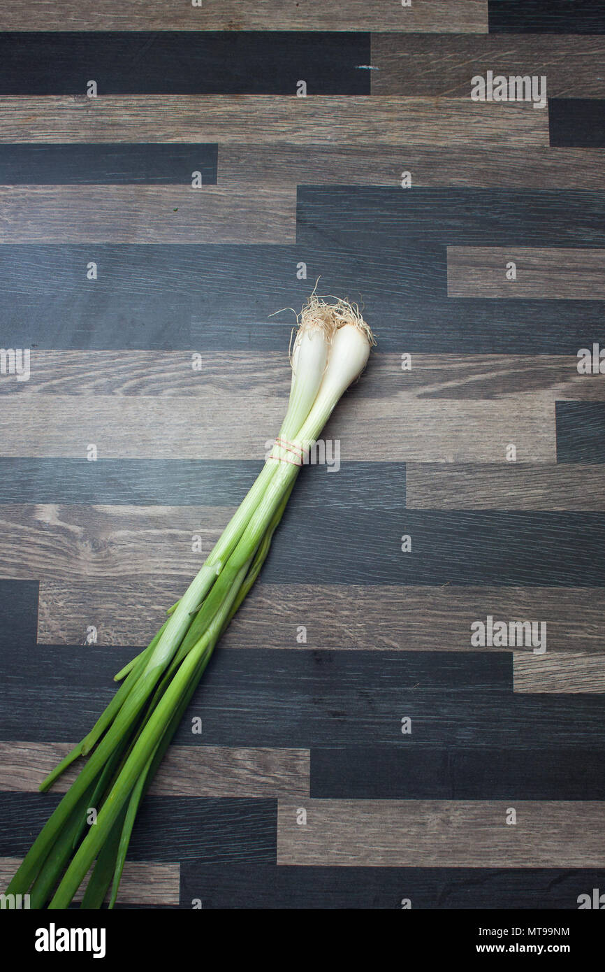 Scallions on a gray kitchen counter top Stock Photo