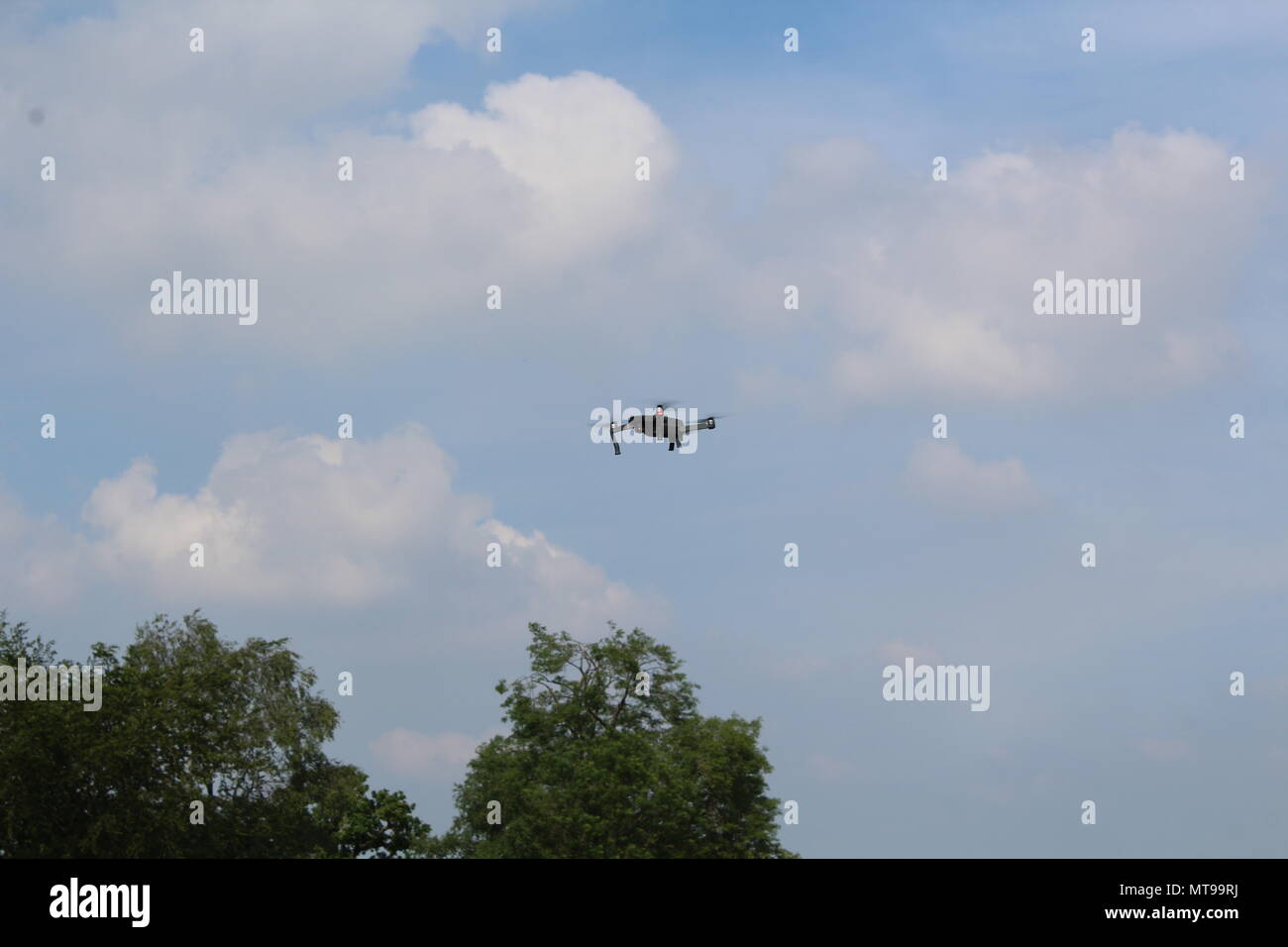Drone flying above the trees Stock Photo