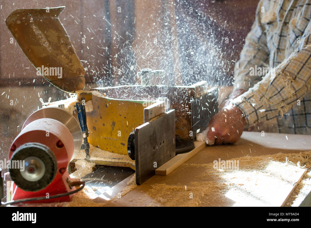 Carpenter tools on wooden table with sawdust. Circular Saw. Cutting a wooden plank Stock Photo