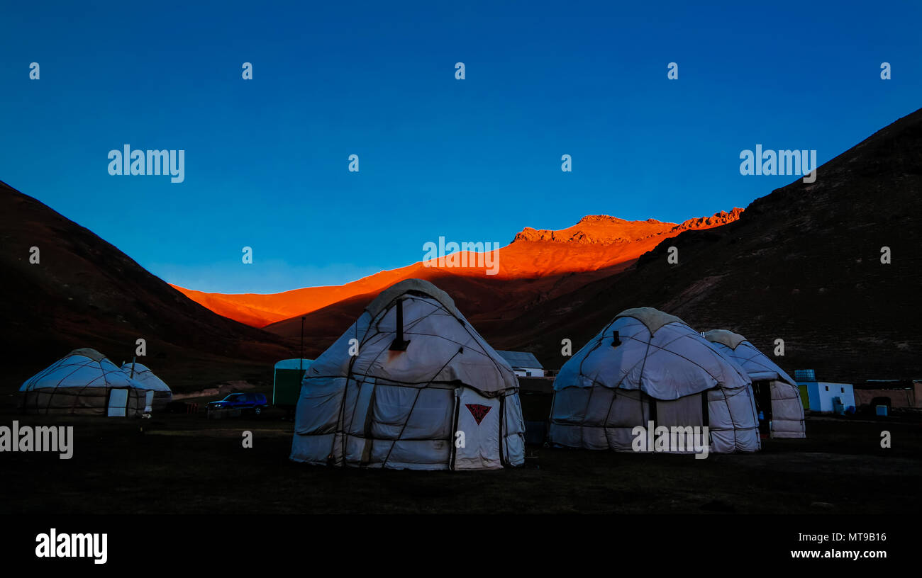 Sunrise over kyrgyz Yurts at Tash-Rabat river and valley at Naryn province, Kyrgyzstan Stock Photo