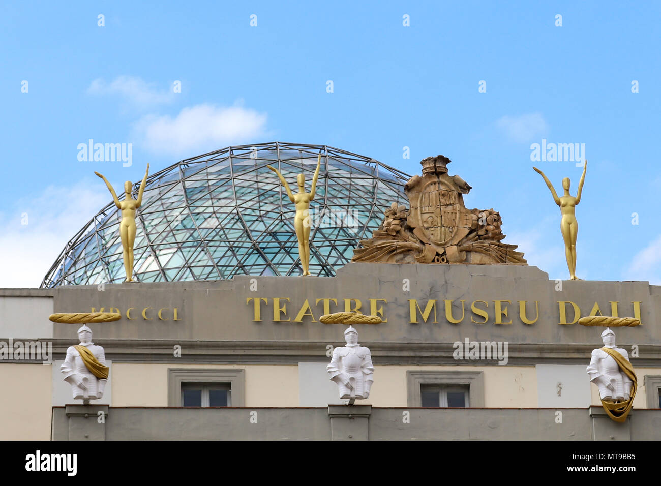 Glass dome and gold statues adorn the top of the Salvador Dali Theatre Museum at the entrance. Figueres, Girona, Catelonia, Spain. Stock Photo