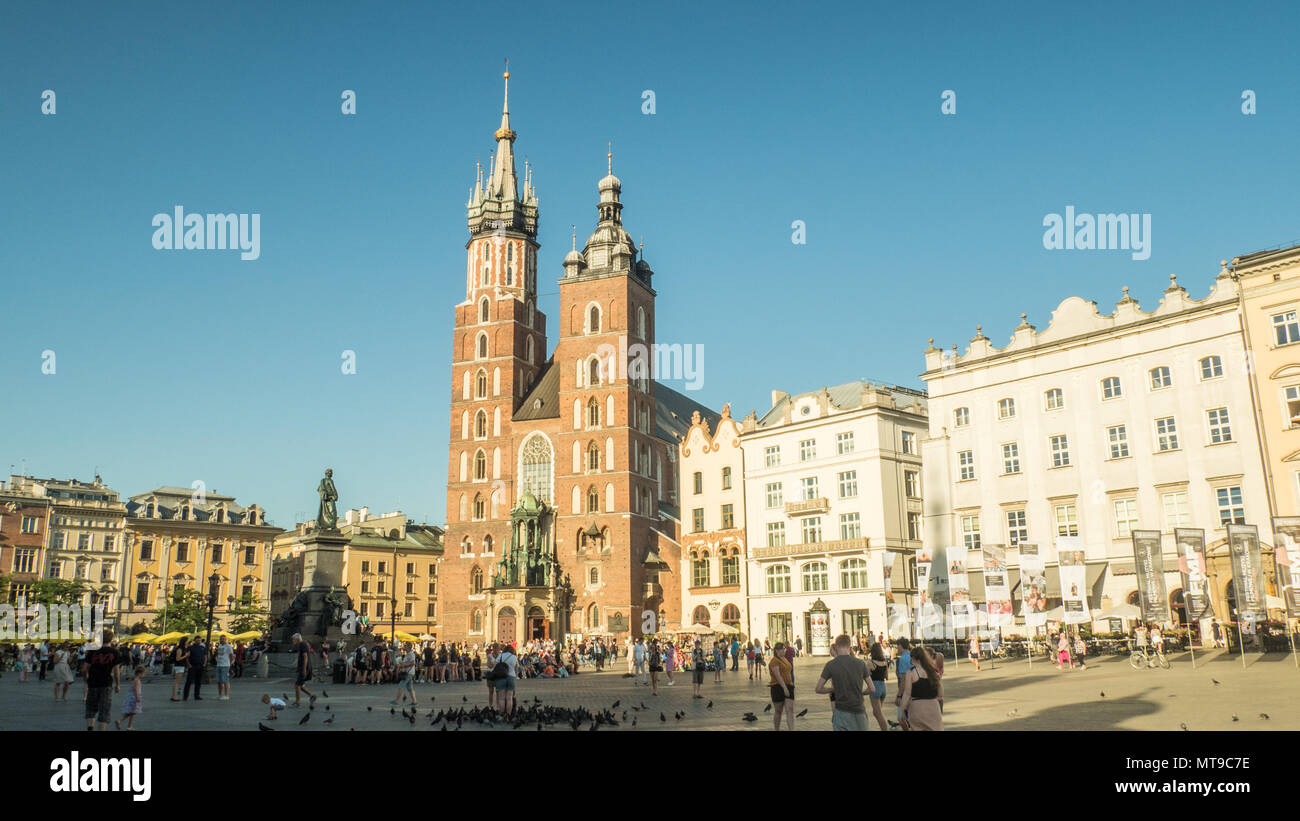 Main (Medieval) Market Square in the old town of Krakow Poland, with the brick Gothic St Marys Church centre. Stock Photo