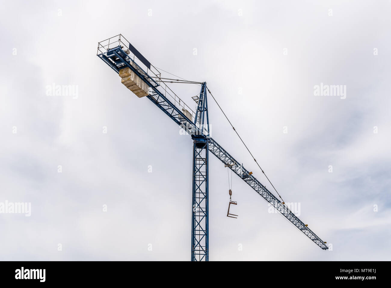 Low angle view of construction crane against cloudy sky. Stock Photo