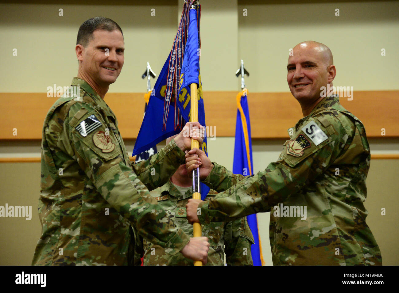 Lt. Col. Kevin Lombardo, right, accepts command of the 341st Missile Security Forces Squadron from Col. Aaron Guill, 341st Security Forces Group commander May 17, 2018, at Malmstrom Air Force Base, Mont. Senior Master Sgt. Paul Anderson, 341st MSFS first sergeant, looks on. (U.S. Air Force photo by Airman 1st Class Tristan Truesdell) Stock Photo