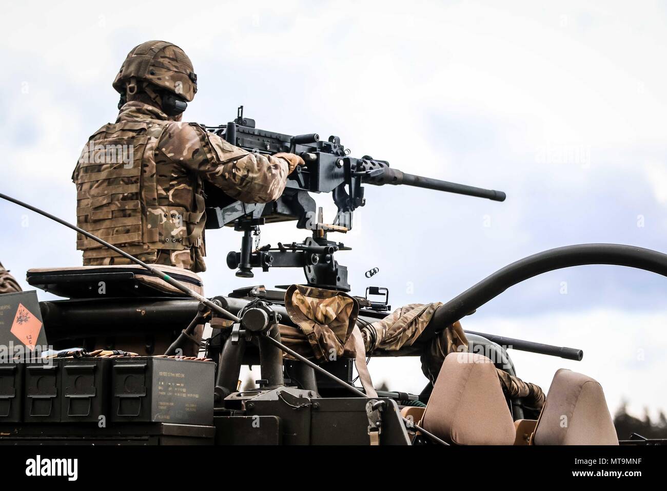 U.K. army Cpl. Will Wright, crew commander with 1st The Queen's Dragoon Guards, fires an L111A1 Heavy machine gun during a four-day weapons training event with Battle Group Poland at Bemowo Piskie Training Area, Poland, on May 17, 2018. Battle Group Poland is a unique, multinational coalition of U.S., U.K., Croatian and Romanian Soldiers who serve with the Polish 15th Mechanized Brigade as a deterrence force in support of NATO’s Enhanced Forward Presence. (U.S. Army photo by Spc. Hubert D. Delany III /22nd Mobile Public Affairs Detachment) Stock Photo