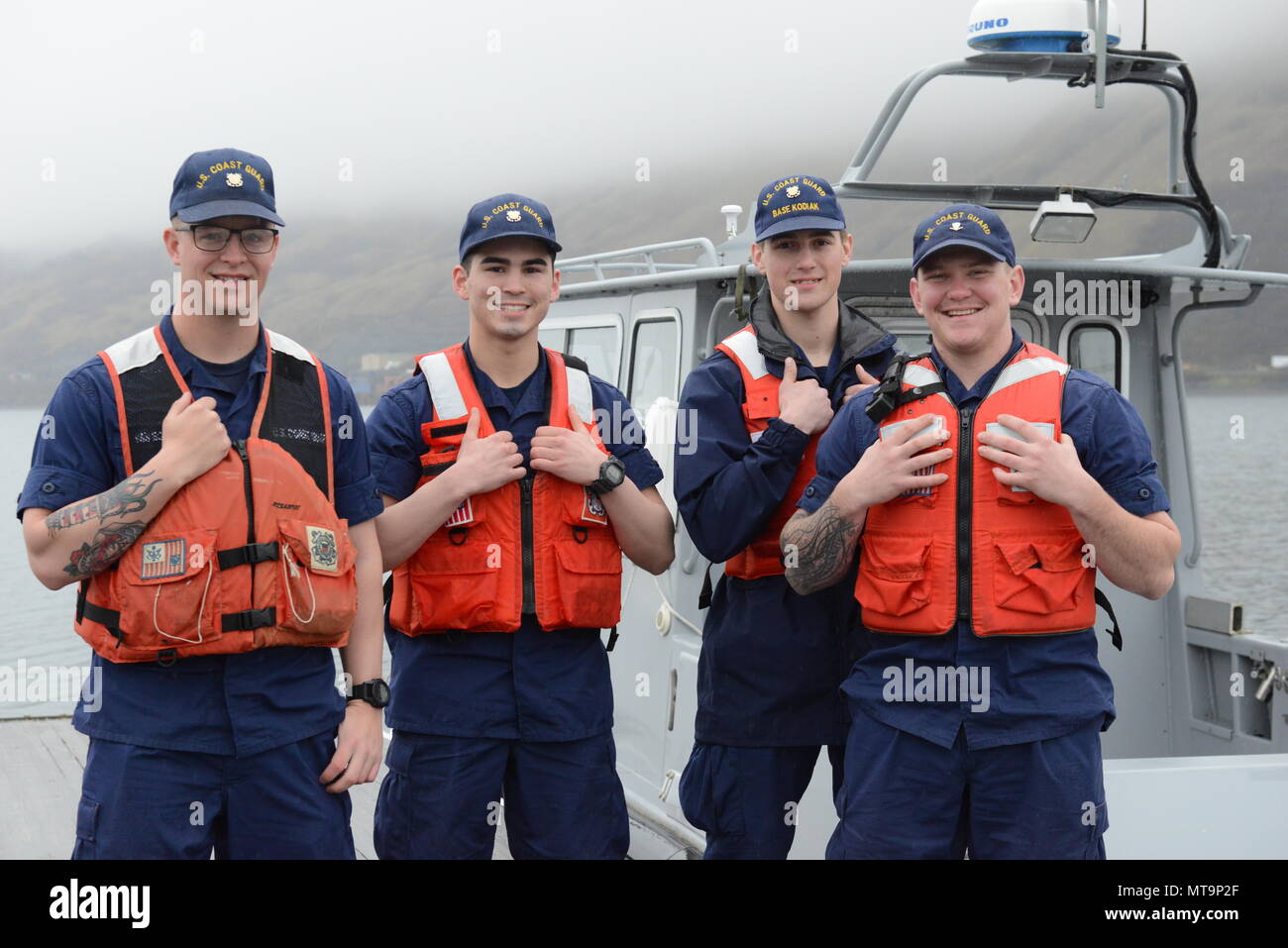 Coast Guard Base Kodiak personnel pose on a Nyman Peninsula pier in Kodiak, Alaska, May 18, 2018