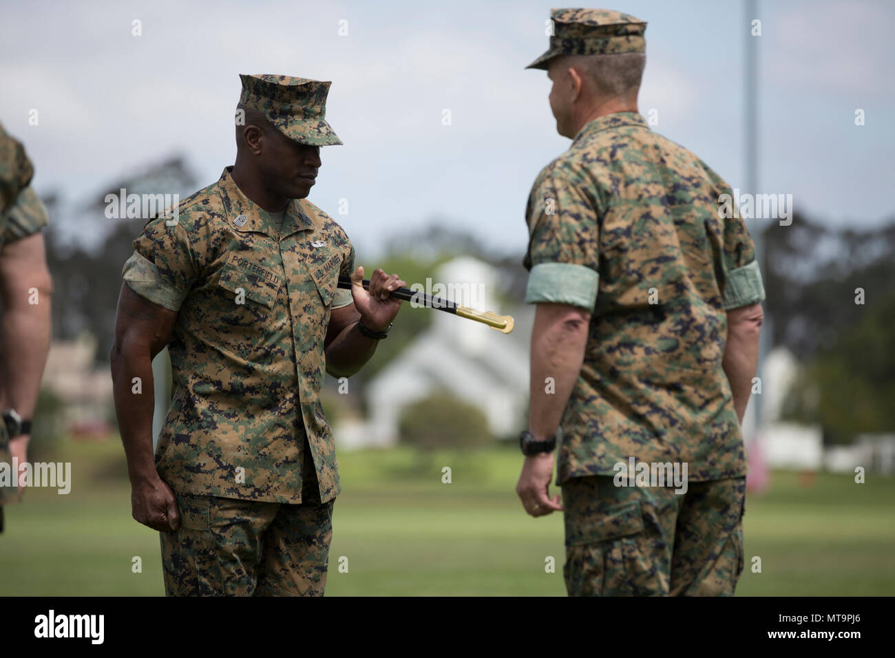 Sgt. Maj. James Porterfield, the incoming I Marine Expeditionary Force sergeant major, receives the sword of office from Lt. Gen. Lewis Craparotta, the I MEF commanding general, during a relief and appointment ceremony on Camp Pendleton, Calif., May 18, 2018. Porterfield replaced Sgt. Maj Bradley Kasal as I MEF sergeant major. (U.S. Marine Corps photo by Cpl. Jacob Farbo) Stock Photo