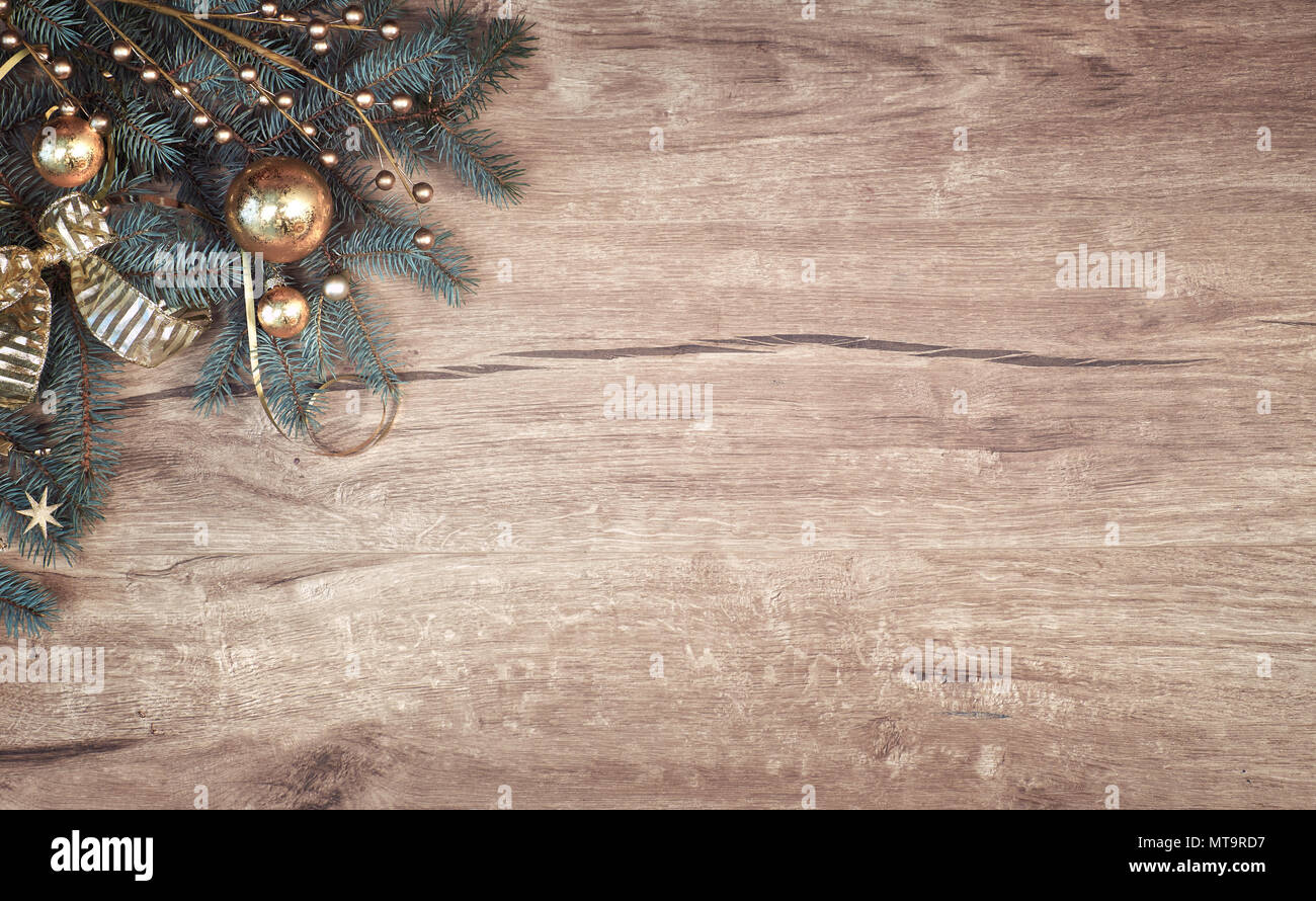 Christmas background on wood with a corner of decorated fir tree ...