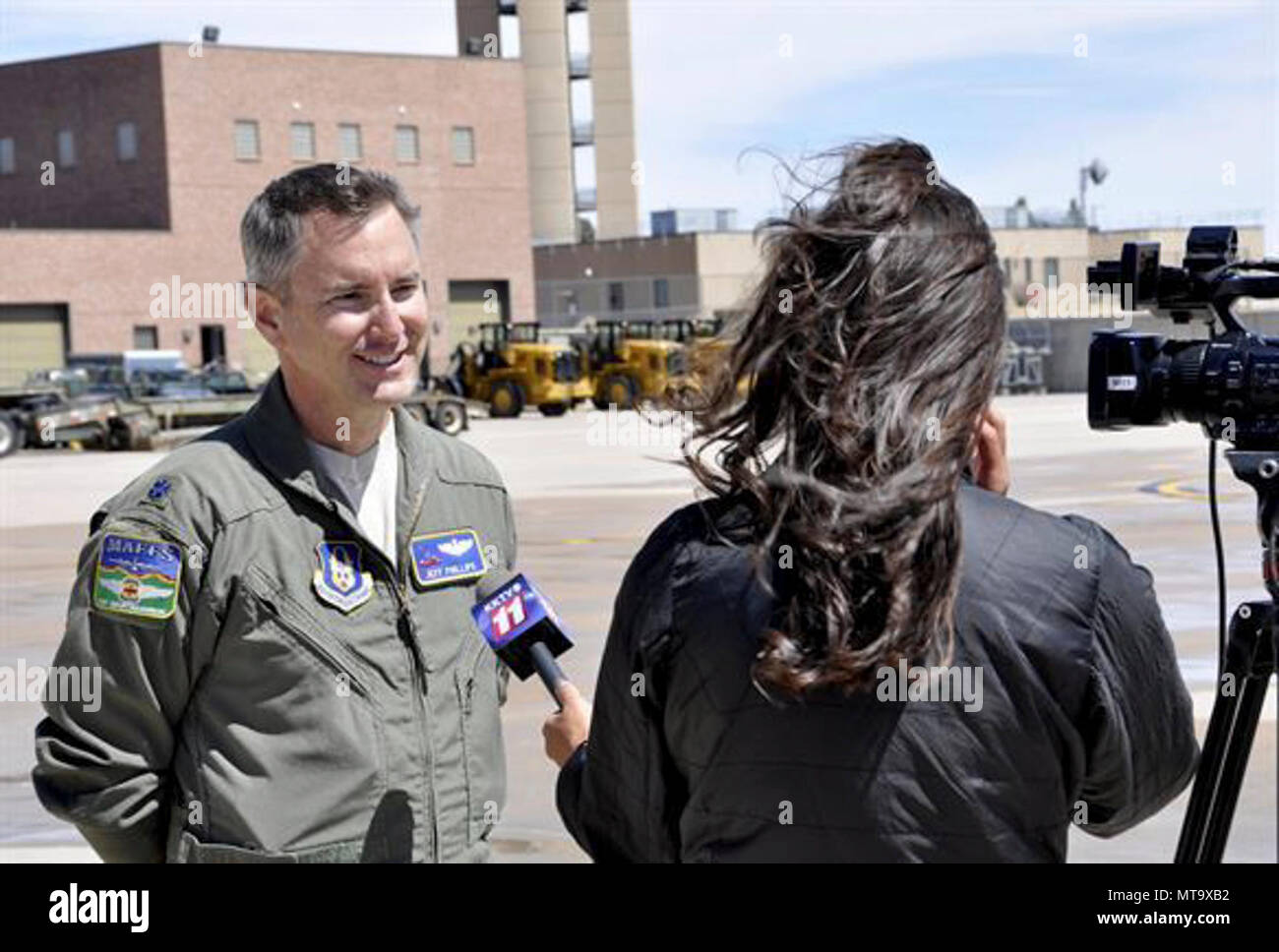 Lt. Col. Jeff Phillips, a Modular Airborne Fire Fighting System-qualified C-130 pilot with the 731st Airlift Squadron, speaks to a television news reporter during the 302nd Airlift Wing’s MAFFS discharge test at Peterson Air Force Base, Colo., April 18. Members of the news media were invited here to witness the Air Force Reservist’s preparations for the upcoming annual U.S. Forest Service MAFFS certification and recertification training event in Boise, Idaho. Stock Photo
