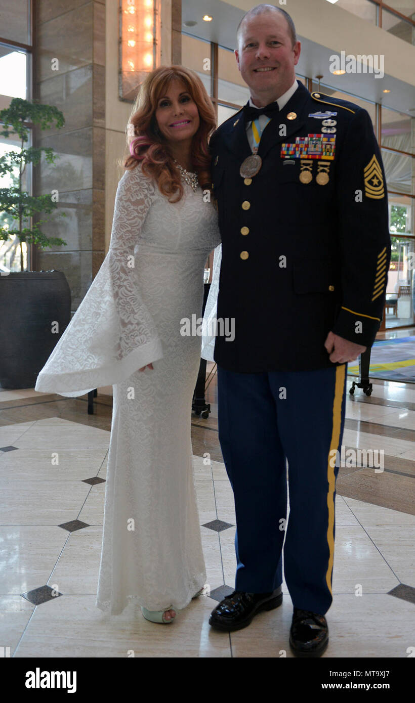 Oregon Army National Guard Sgt. Maj. Vinnie Jacques (right), Senior Enlisted Advisor to Joint Domestic Operations Commander, pauses for a photo with Suzanne DeLaurentiis, a Hollywood film producer and Veteran advocate, at a gala event sponsored by Suzanne DeLaurentiis Productions at the InterContinental Hotel in Burbank, California, March 3, 2018. Jacques was awarded the Hero Award during the gala. He was wounded in combat in 2004 while serving with 3rd Platoon, Bravo Company, 2nd Battalion, 162nd Infantry Regiment, which received the Presidential Unit Citation for their heroic efforts during  Stock Photo