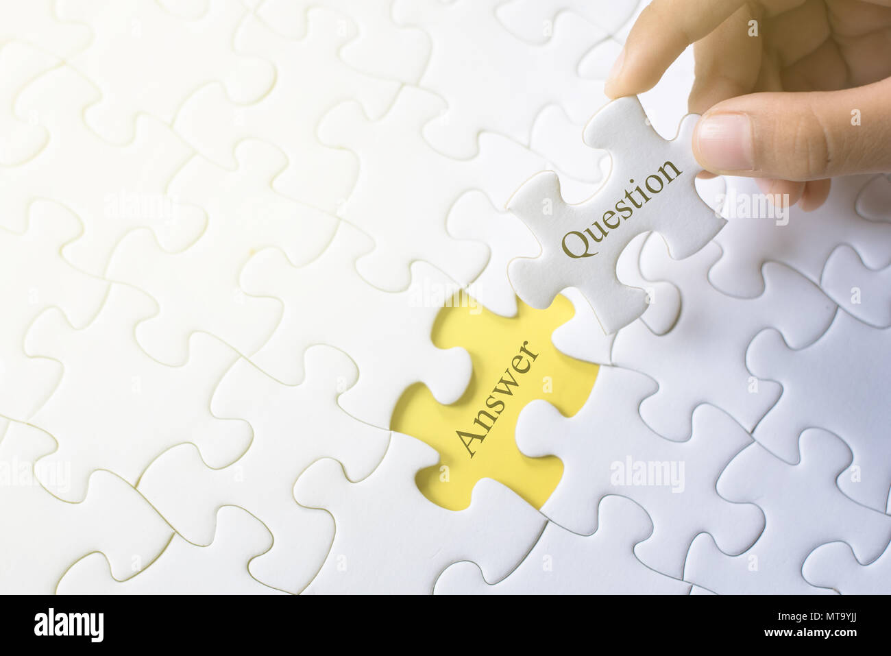 hand holding question and answer word on jigsaw puzzle. q&a, faq and
