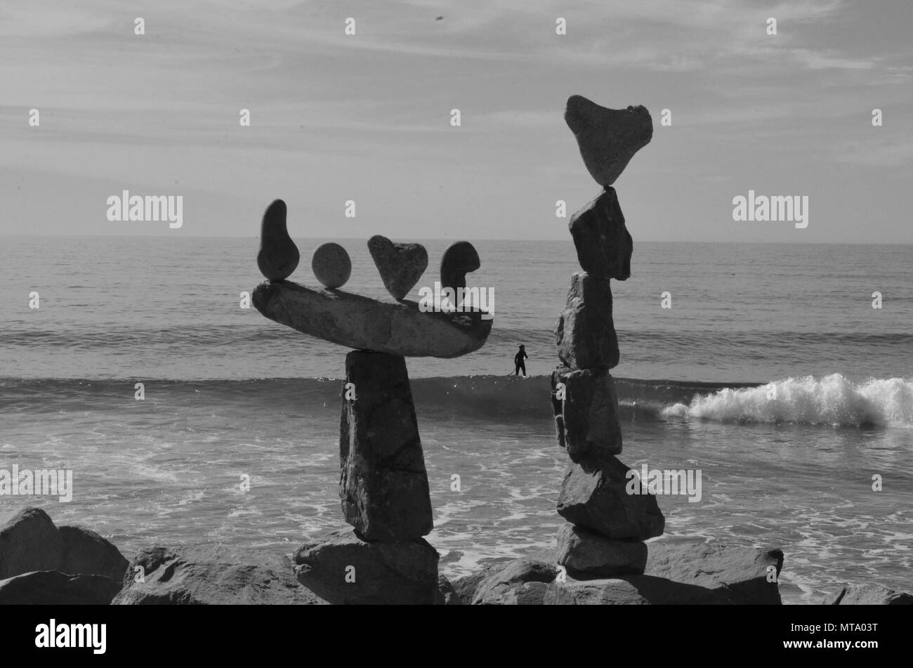 Balancing rock formation at Carlsbad State Beach. Pacific ocean in the background. Black and white photo. Stock Photo