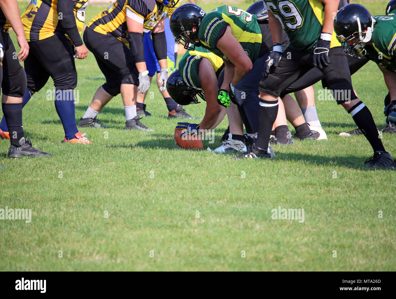 American football players on the scrimmage line ready for action Stock Photo