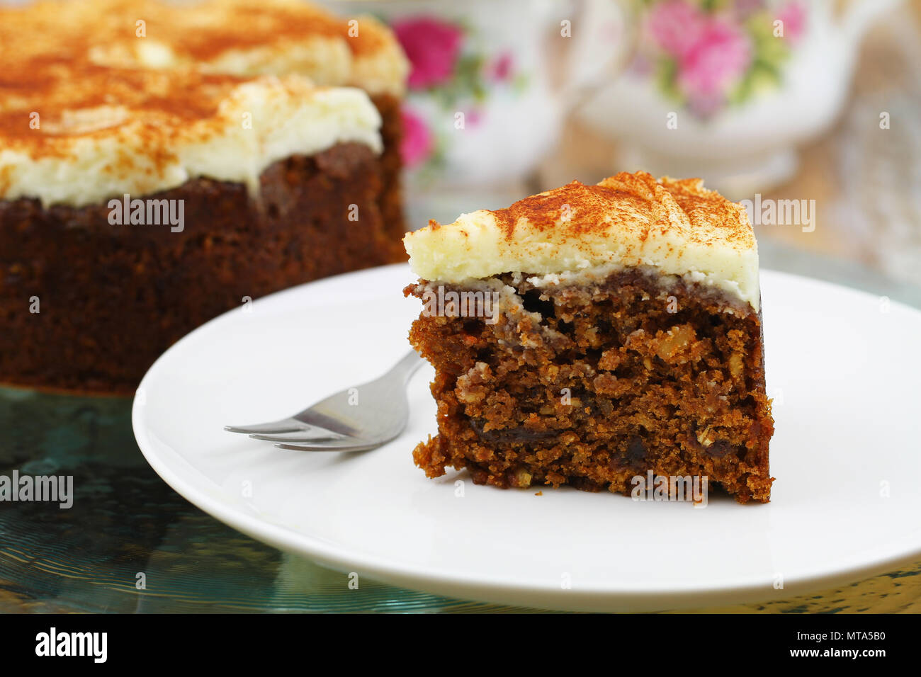 Slice of rich carrot cake with walnuts and marzipan icing Stock Photo