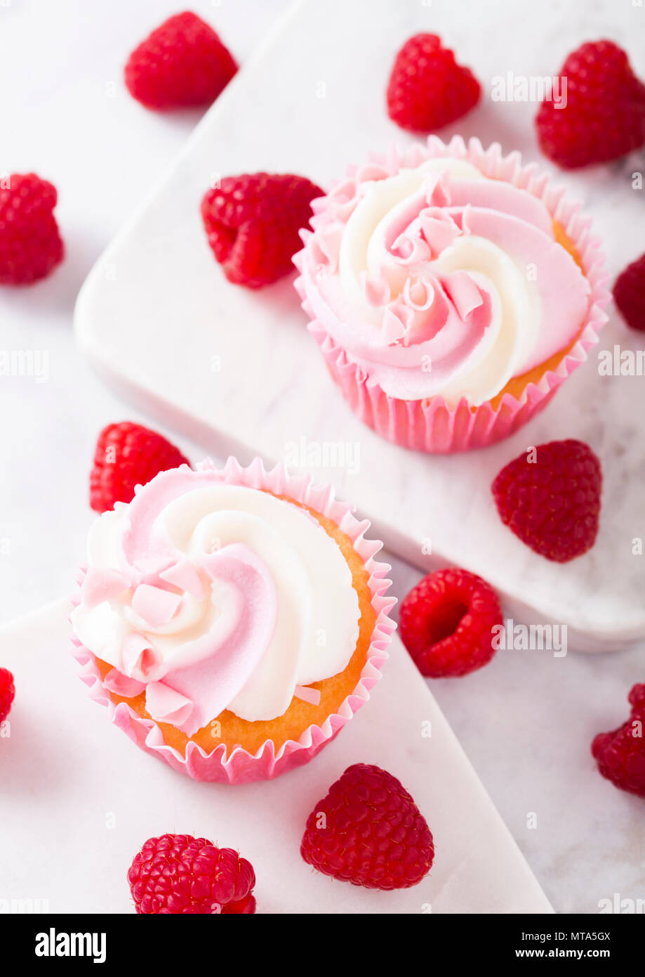 Cupcake muffin with raspberry cream dessert on marble background with freshraspberry Stock Photo