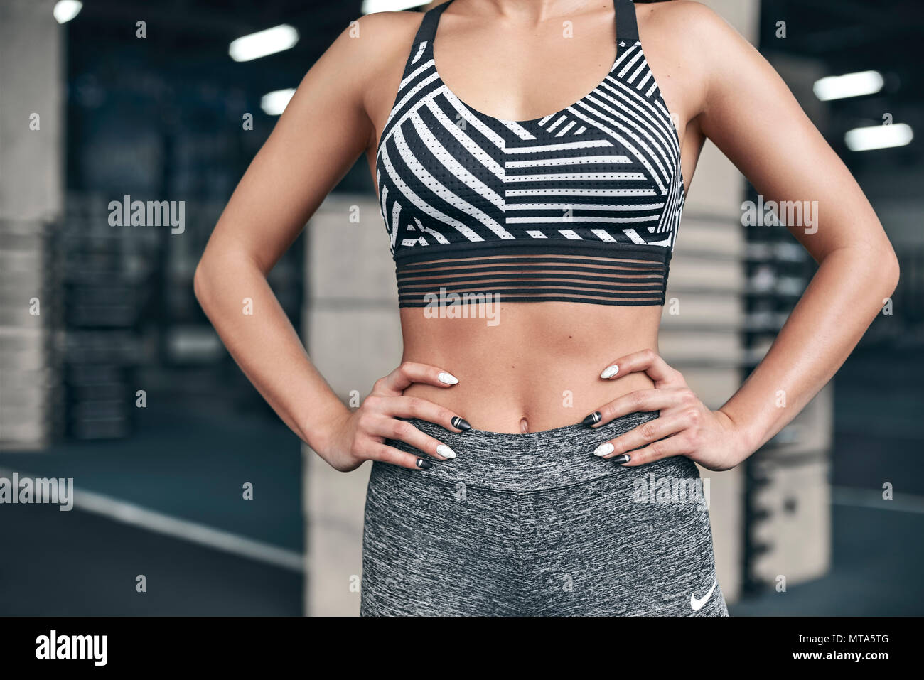 Young Fit Woman Exercises In Gym Standing Confident Abs Close Up Good Body Stock Photo Alamy