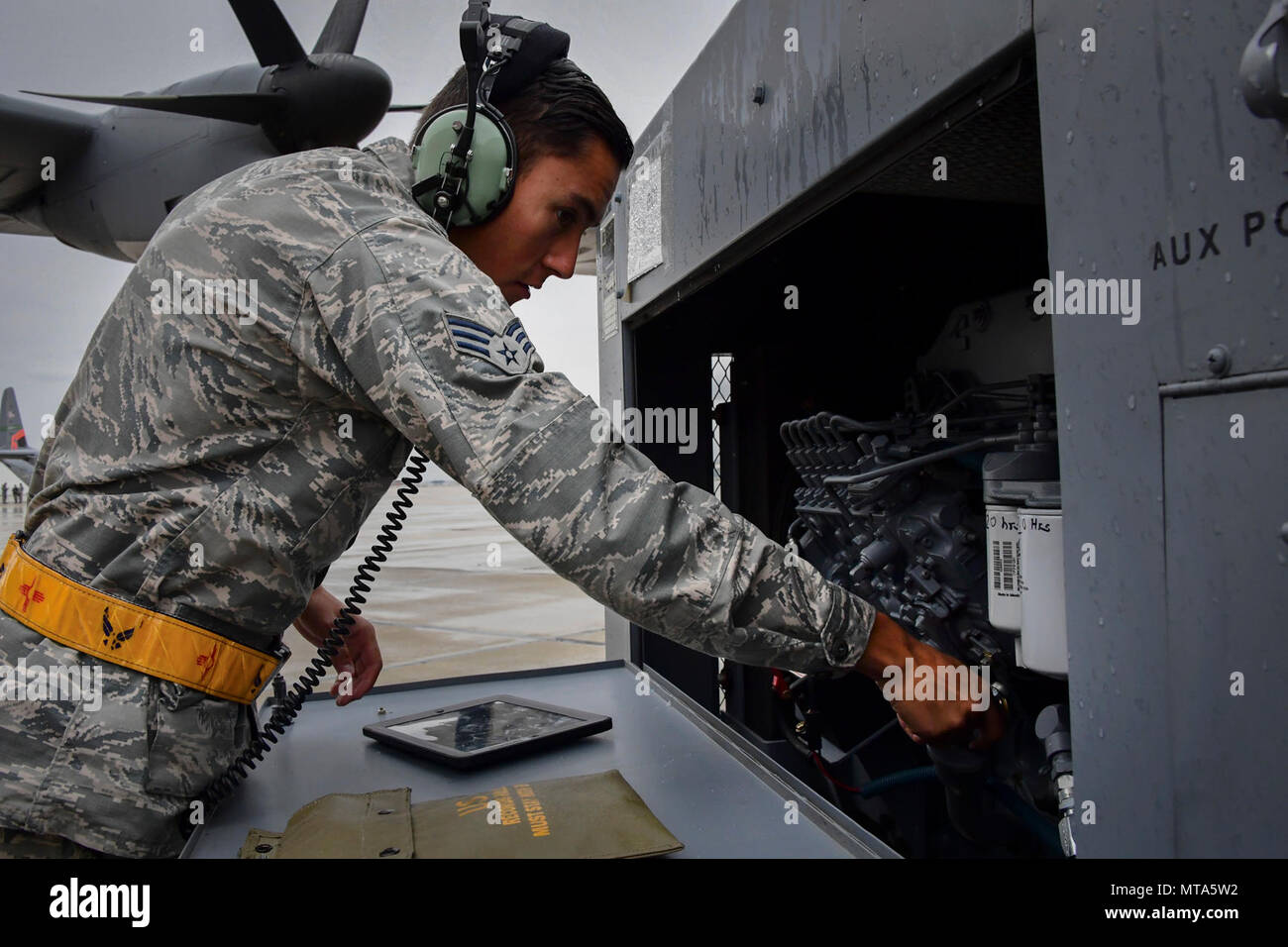 U.S. Air National Guard member Senior Airman Santos Casaus from the 146th Maintenance Squadron checks the oil levels on a generator that will power a C-130J aircraft at Gowen Field, Idaho, April 20, 2017. Casaus and a maintenance crew from the 146th Airlift Wing will be providing maintenance service on two C-130J aircraft equipped with the Modular Airborne Fire Fighting System (MAFFS) from the Channel Islands Air National Guard Station during the week-long multi-agency wildfire training with the U.S. Forest Service, CAL FIRE, and multiple Air National Guard and U.S. Air Force Reserve wings. Stock Photo