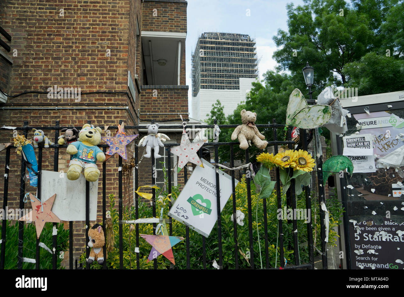 View of of nearby council housing houses and memorial objects by burnt