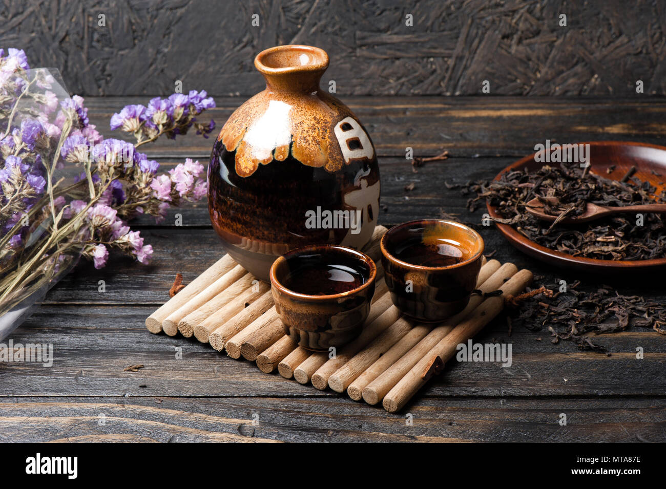 the classic brown japanese tea set on wooden table, with the word