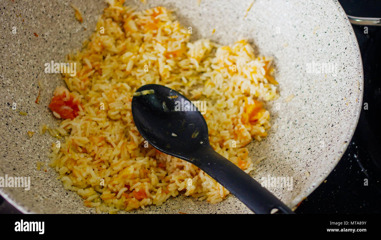 Rice italian pasta with safron and fresh tomato. Traditional culture Italy dish Stock Photo