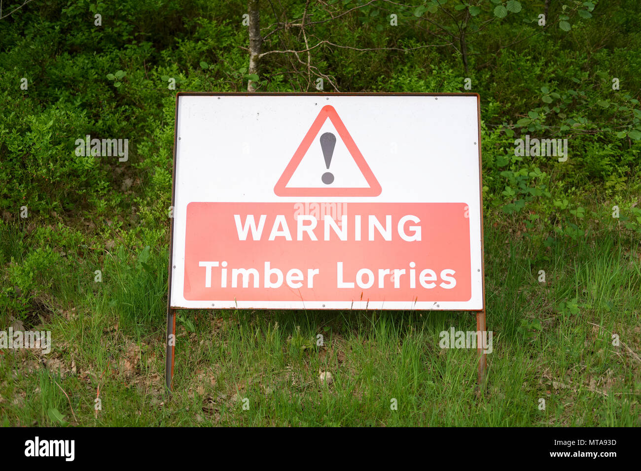 timber lorries trucks wagons warning sign on road forest woodlands