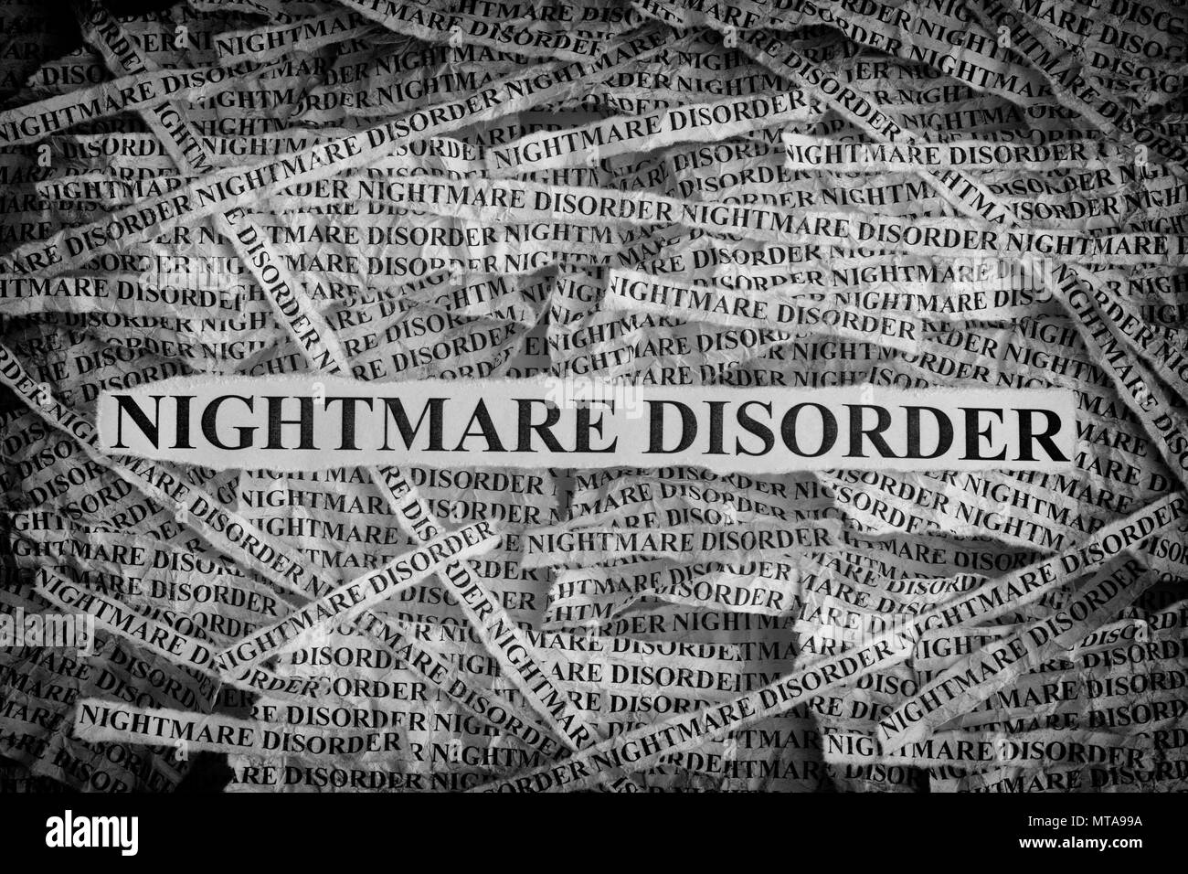 Nightmare Disorder. Torn pieces of paper with the words Nightmare Disorder. Concept Image. Black