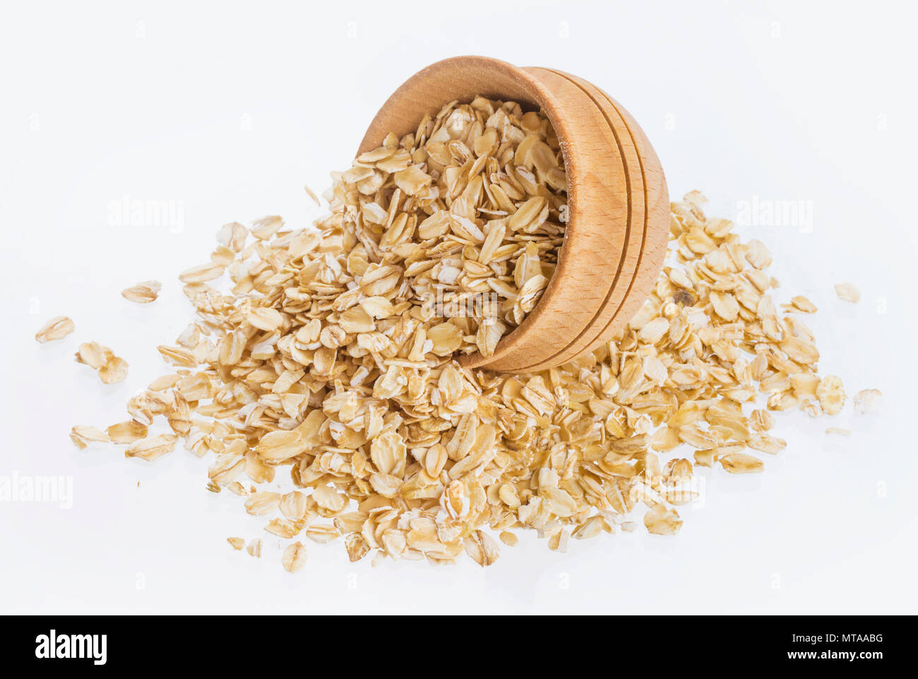 Oat flakes in wooden bowl isolated on white background Stock Photo