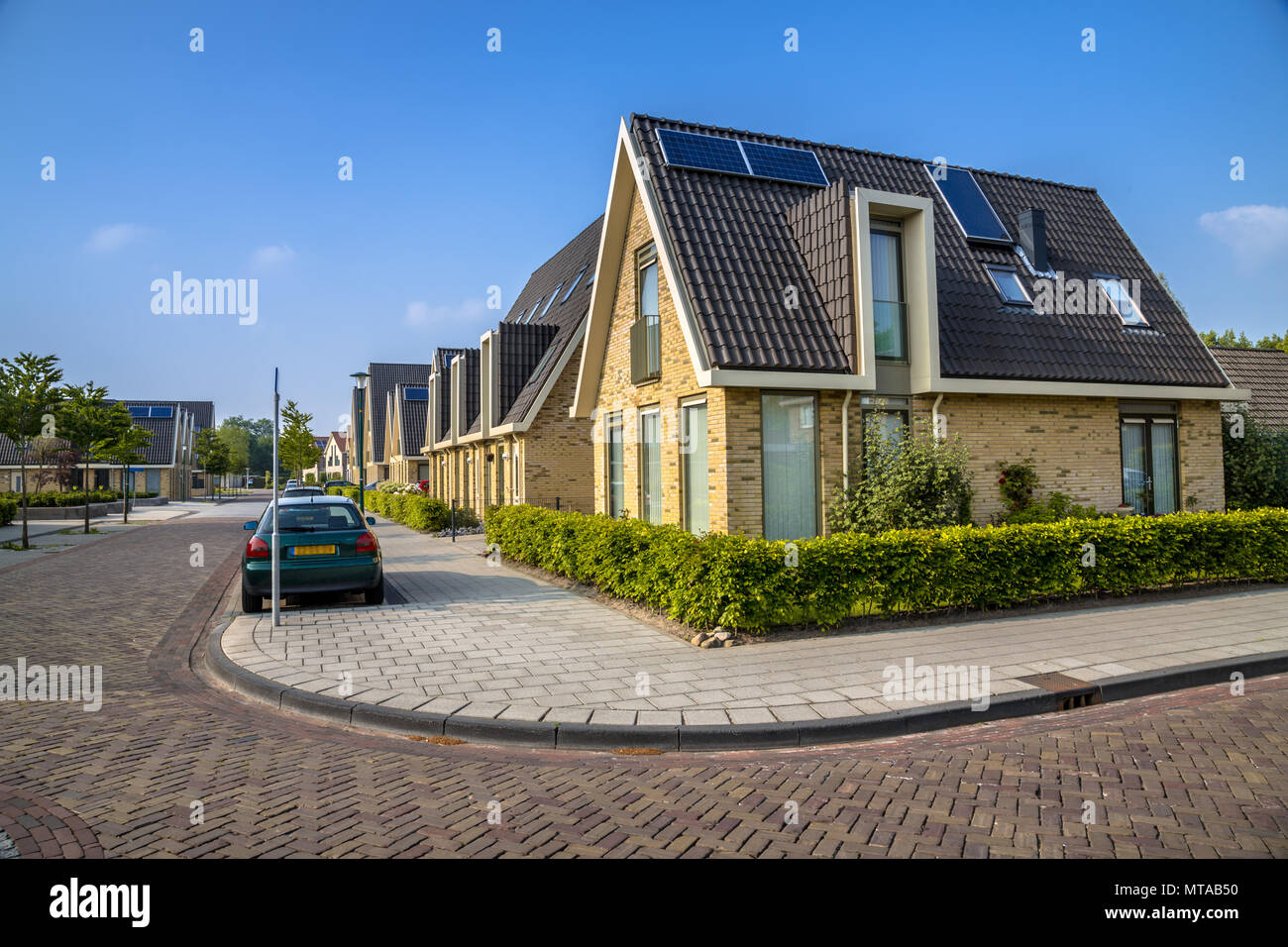 Modern family houses in residentieal street of middle sized city in Friesland Stock Photo