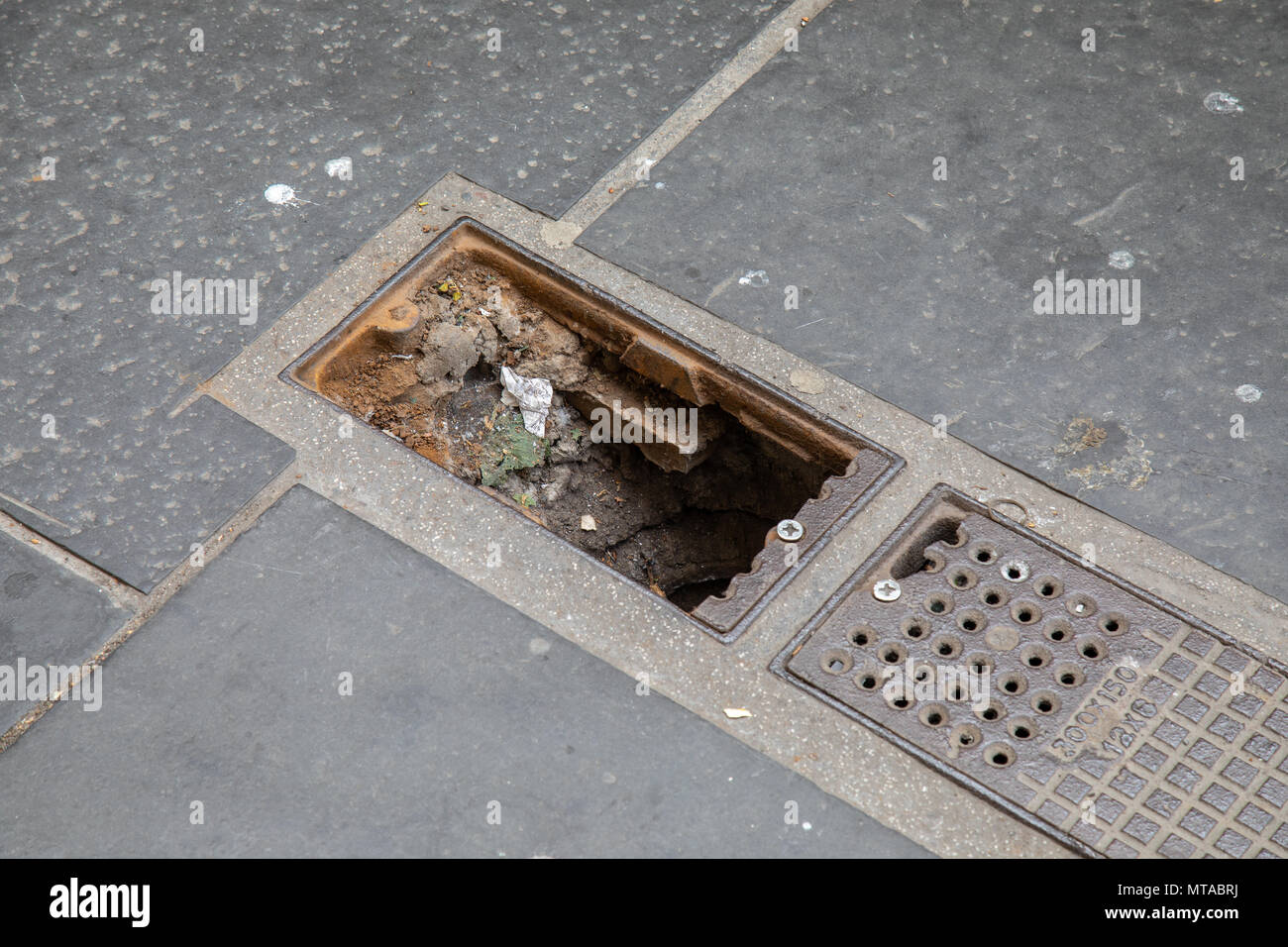 A missing manhole cover in Gordon Street Glasgow Stock Photo